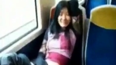 Asian milf rubs her clit on a train.